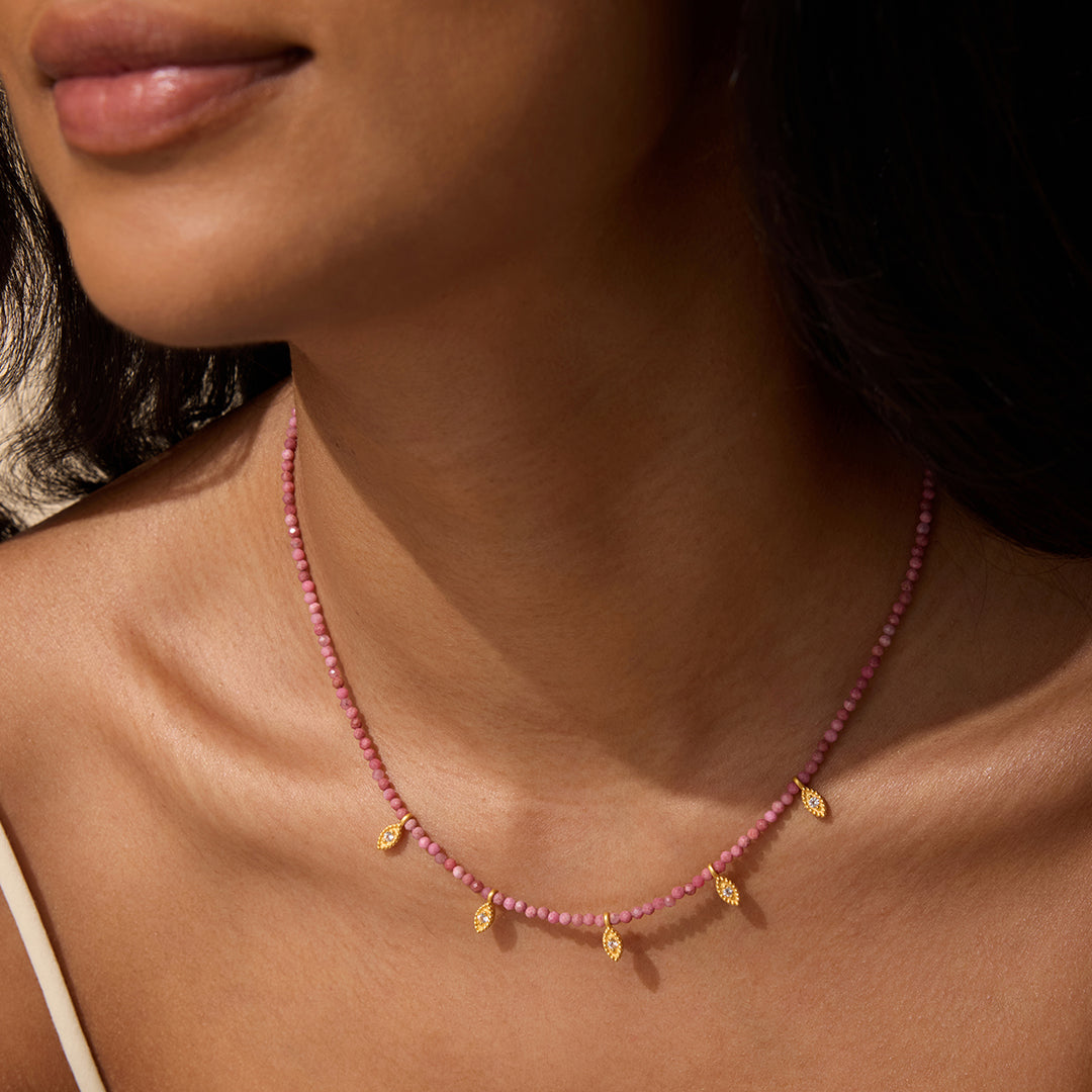 Model wearing Transformed by Healing Rhodonite Lotus Petal Choker Necklace, exemplifying beauty and meaning in spiritual jewelry, ideal for yoga and protection.