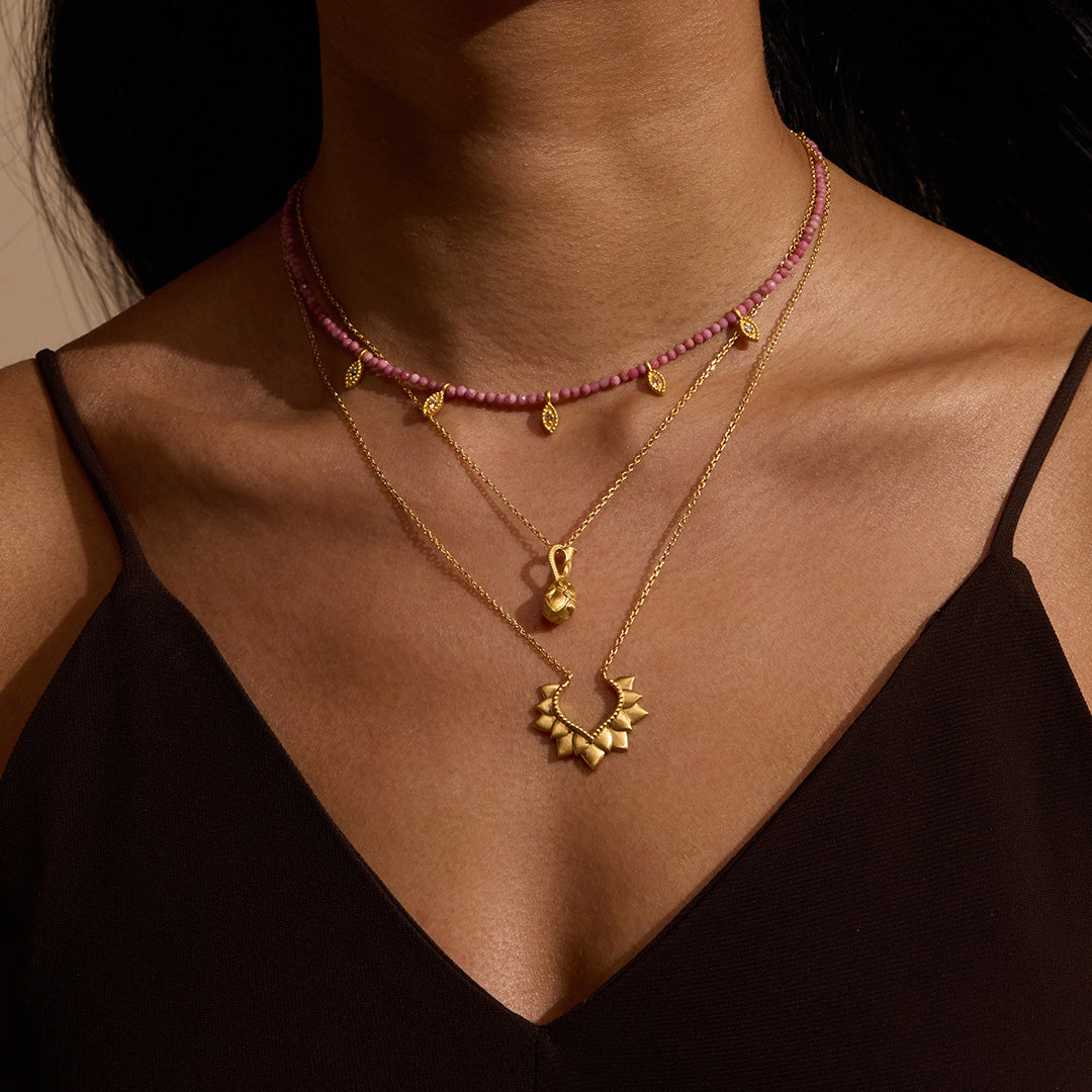 Layered necklaces including the Transformed by Healing Rhodonite Lotus Petal Choker Necklace, representing transformation in spiritual jewelry, talisman for inner growth and manifestation.