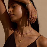 Woman adorned with the Transformed by Healing Rhodonite Lotus Petal Choker Necklace, reflecting spiritual essence and beauty, symbolizing new beginnings, perfect for meditation and yoga.