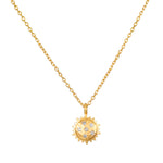 Gold-toned sun pendant necklace with clear crystal accent stones on adjustable chain.