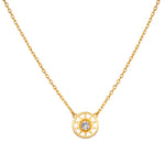 Gold-toned necklace with sun-shaped pendant featuring clear crystal center stone suspended from delicate chain.