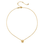 Gold chain necklace with small circular sun pendant set with clear stone at center.