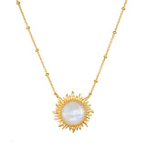 Gold-tone necklace with a sun-shaped pendant featuring a white iridescent moonstone center and beaded chain.