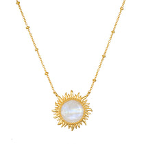 Gold-tone necklace with a sun-shaped pendant featuring a white iridescent moonstone center and beaded chain.