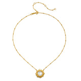 Gold-tone chain necklace with beaded links and a sun-shaped pendant featuring a white moonstone center.
