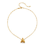 Gold-tone chain necklace with delicate beaded links and a faceted crystal pendant shaped like a firefly at the center.