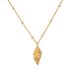 Gold-toned conch shell pendant with opal stone center on segmented gold chain necklace.