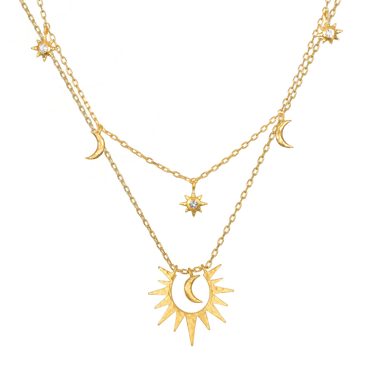 Two layered gold chain necklaces with small crescent moons, crystal-set stars, and a larger open sunburst pendant holding a crescent.