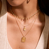 Model wearing the Joyful Choker Necklace layered with additional gold jewelry, creating a stunning spiritual look. This necklace serves as a meaningful talisman for protection and manifestation, blending fashion with spiritual elements.