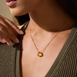 A close-up of a woman wearing a Brighter Than Sunshine Citrine Necklace, showcasing its warm citrine briolette stone, embodying spiritual jewelry that symbolizes happiness and protection. Perfect for meditation and manifestation.