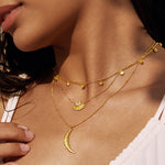 Close-up of the Moon Phases of Femininity Gold Choker layered with additional gold necklaces, highlighting its intricate details. This choker reflects the beauty of sacred feminine energy, serving as a powerful amulet for meditation, yoga, and meaningful daily wear.