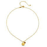 Gold-toned chain necklace with circular chakra pendant featuring engraved symbol and small red stone accent.