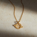 The Equal Means Equal necklace displayed elegantly on a textured surface, showcasing its symbolic gold charm that represents equality. This meaningful piece of spiritual jewelry is perfect for meditation, yoga, and a reminder of sacred values, making it an ideal manifestation gift.