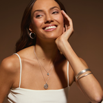 A model showcasing the Mother Moon Silver Locket Necklace, exuding charm and elegance, embodying the essence of spiritual jewelry, ideal as a talisman for personal growth and protection during meditation and yoga.