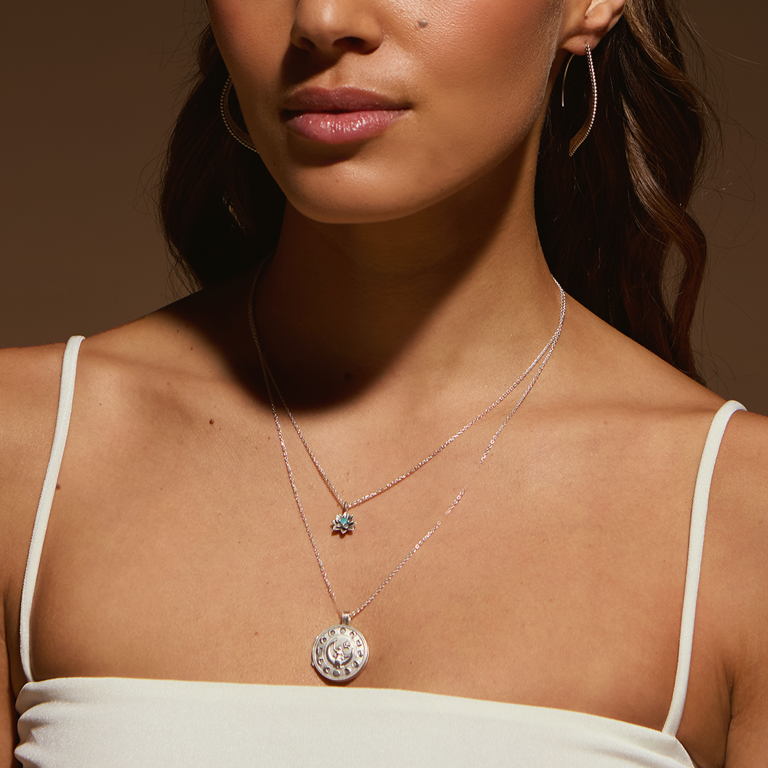 Model showcasing the layered Soul Renewal Silver Lotus Necklace alongside another stylish piece, representing spirituality and manifestation. Perfect for those seeking protection and meaning in their jewelry collection.