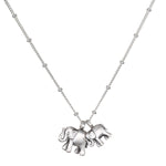 Elephant Love Silver Necklace featuring two intricately designed sterling silver elephants on a delicate chain, symbolizing strength, wisdom, and good fortune. This spiritual jewelry is perfect for meditation and serves as a meaningful talisman. Ideal for yoga practitioners and those interested in manifestations of charm and protection.