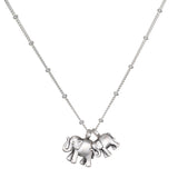Elephant Love Silver Necklace featuring two intricately designed sterling silver elephants on a delicate chain, symbolizing strength, wisdom, and good fortune. This spiritual jewelry is perfect for meditation and serves as a meaningful talisman. Ideal for yoga practitioners and those interested in manifestations of charm and protection.