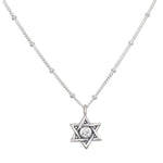 Guiding Faith Silver Star of David Necklace showcased elegantly, featuring a sparkling white topaz at its center. This spiritual jewelry serves as a talisman for protection and meditation, embodying the meaning of faith and connection to the universe. Perfect for yoga practitioners and those seeking meaningful adornments for manifestation.