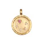 Zodiac Coin Charm featuring a pink gemstone, symbolizing love and compassion, designed for spiritual jewelry and meditation. This talisman offers zodiac protection and meaning, enriching yoga practices and manifestation efforts.