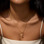 A model wearing the Soul Renew Gold Lotus Charm on a delicate necklace, showcasing its beauty and significance. This spiritual piece embodies the essence of meditation, manifestation, and protection, ideal for individuals who appreciate meaningful jewelry that resonates with the sun and moon energy.