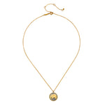 A thin gold chain necklace with an adjustable extender holds a round pendant featuring a gold elephant on a dark background.