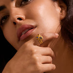 A portrait of a model showcasing the Vibrant Beauty Cluster Gemstone Ring Set, with a focus on the labradorite and citrine stones. This spiritual jewelry acts as a protective charm for those seeking deeper connection during meditation and yoga practices.