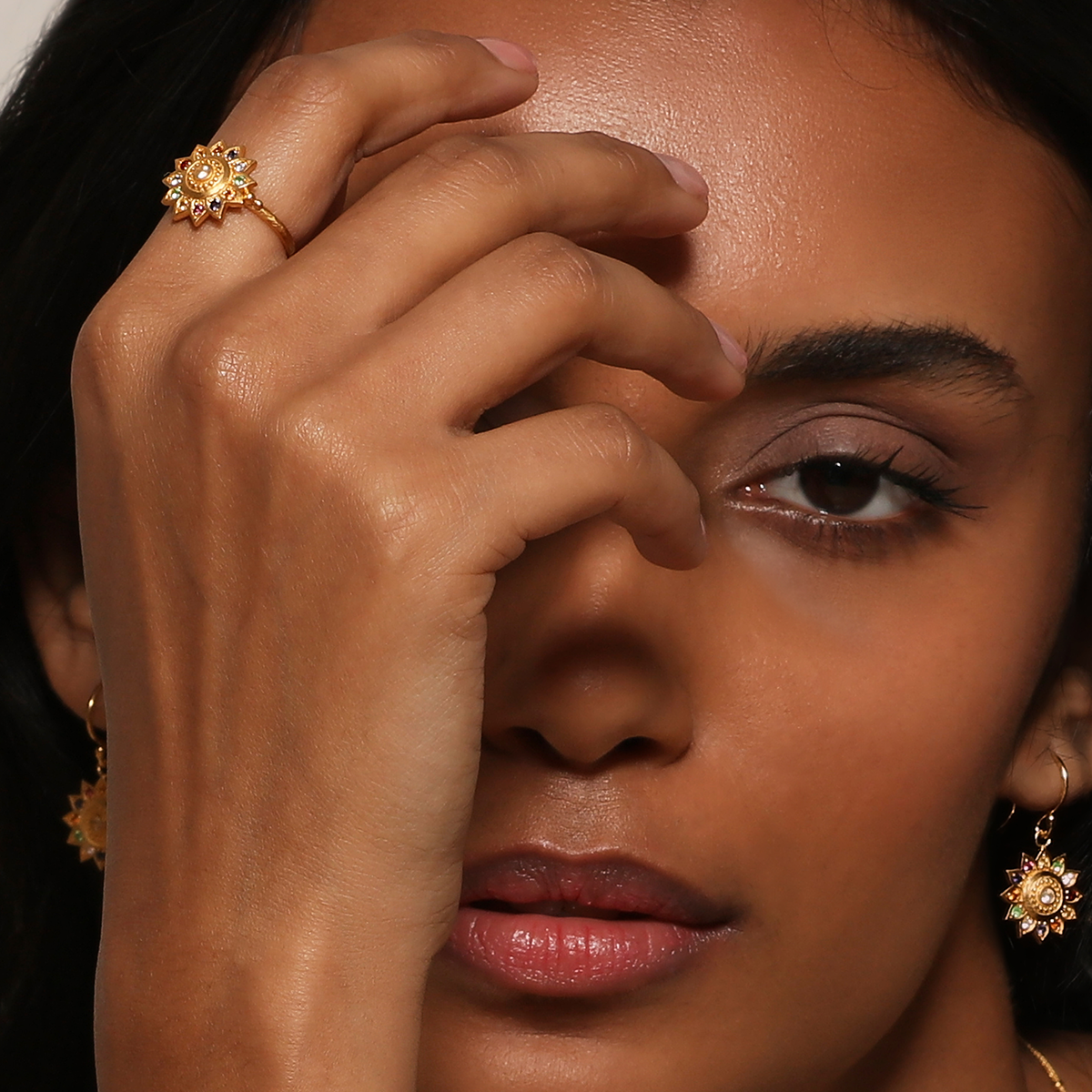 A model elegantly wearing the Vibrant Self Multi Stone Lotus Ring, highlighting its beauty as a significant spiritual jewelry piece. This ring complements a meditation practice, serving as a meaningful talisman for protection and personal growth in yoga.