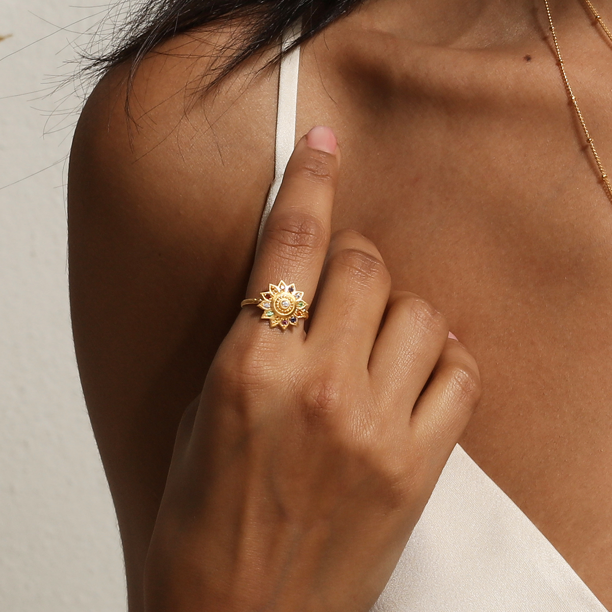 Close-up of the Vibrant Self Multi Stone Lotus Ring on a hand, showcasing its intricate design with vibrant healing gemstones, representing new beginnings and potential. This spiritual jewelry is perfect for meditation and manifestation, making it a meaningful charm for yoga and zodiac practices.