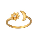 The Spirit in Transformation Lotus Moon Ring showcases an elegant design featuring a lotus flower and a crescent moon, symbolizing new beginnings and protection. This 18kt gold plated ring is a meaningful piece of spiritual jewelry for meditation and manifestation, perfect for those who value talismans and the spiritual connection to the sun and moon.