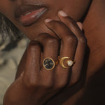 A close-up of a hand wearing the Shine in Sisterhood Constellation Ring alongside other rings, symbolizing the beauty of spiritual jewelry and meaningful connections in yoga and protection.