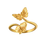 A stunning Freedom to Soar Adjustable Butterfly Ring featuring two elegantly designed butterflies in 18kt gold plate, symbolizing transformation and hope. This spiritual jewelry piece is perfect for meditation and serves as a talisman for positive energy and protection, making it meaningful for yoga and manifestation practices.