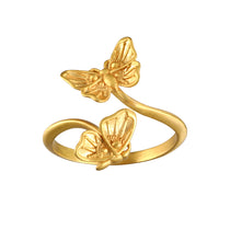 A stunning Freedom to Soar Adjustable Butterfly Ring featuring two elegantly designed butterflies in 18kt gold plate, symbolizing transformation and hope. This spiritual jewelry piece is perfect for meditation and serves as a talisman for positive energy and protection, making it meaningful for yoga and manifestation practices.