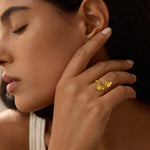 A close-up of a woman's hand showcasing the Freedom to Soar Adjustable Butterfly Ring, symbolizing freedom and transformation. This stunning piece of spiritual jewelry serves as a meditation talisman that connects with the energy of the sun and moon, perfect for meaningful practices and manifestation.