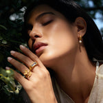 A serene close-up of a woman wearing the Freedom to Soar Adjustable Butterfly Ring along with a pearl earring, embodying the essence of spiritual jewelry and meditation. This elegant piece symbolizes transformation and hope, making it a meaningful talisman for yoga enthusiasts and those interested in spiritual practices.