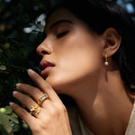 A graceful image of a woman adorned with the Freedom to Soar Adjustable Butterfly Ring, highlighted against a natural backdrop. This beautiful ring represents hope and transformation, making it ideal for spiritual jewelry lovers and individuals seeking meditative protection and meaningful energy in their lives.