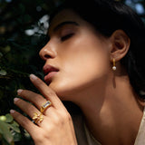 A graceful image of a woman adorned with the Freedom to Soar Adjustable Butterfly Ring, highlighted against a natural backdrop. This beautiful ring represents hope and transformation, making it ideal for spiritual jewelry lovers and individuals seeking meditative protection and meaningful energy in their lives.
