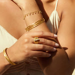 The Abundant Prosperity Blue Topaz Ring featured among stylish bracelets on a sunny background, evoking themes of spiritual jewelry, meditation, and meaningful manifestation for those aligned with the sun and moon.