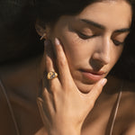 A woman wearing the Celestial Balance Yin Yang White Topaz Ring, showcasing its intricate design symbolizing spiritual harmony. This spiritual jewelry serves as a meaningful talisman for meditation and manifestation, embodying the energies of the sun and moon, perfect for yoga enthusiasts.