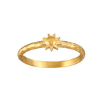 Gold band ring with a star-shaped ornament on top.