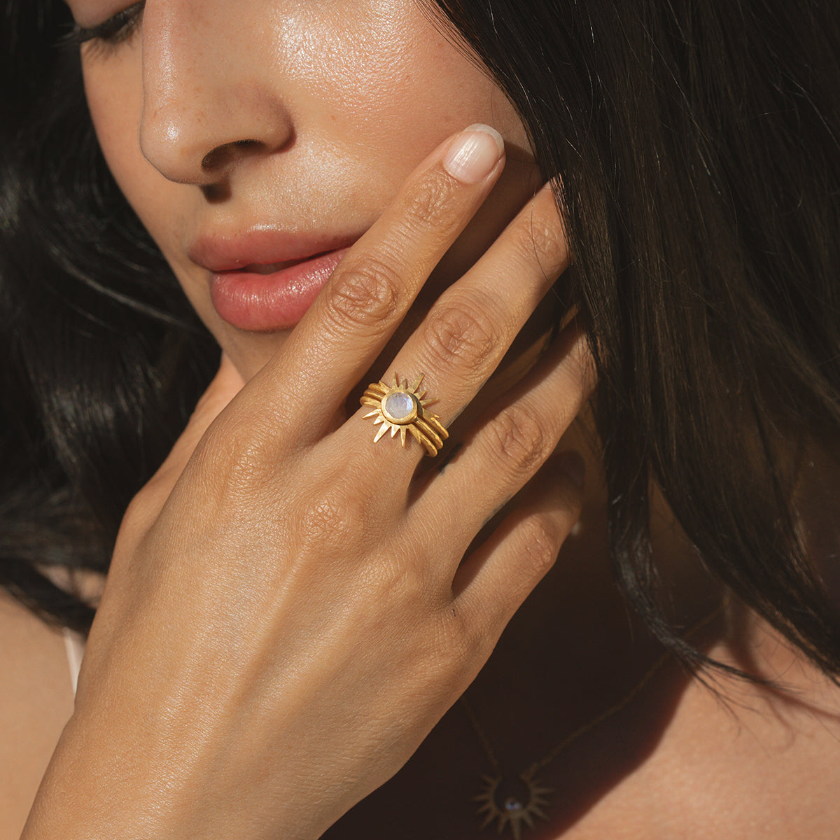 A model wearing the Light Seeker Moonstone Starburst Nested Ring Set, highlighting the elegant gold rings featuring moonstone, embodying spiritual meaning, ideal for yoga practitioners and those drawn to talismans and zodiac energies.