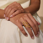 A person wearing the Rooted in Transformation Lotus Adjustable Open Ring, embodying the essence of spiritual jewelry and meaningful expression with themes of meditation, protection, and yoga.