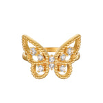 Gold butterfly ring with white topaz stones set in center and beaded edges on wings.