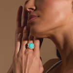 A close-up of a woman wearing the Nurture Your Voice Turquoise Silver Ring, showcasing its vibrant turquoise stone and its elegant beaded design, perfect for those seeking spiritual jewelry for protection and manifestation.