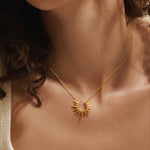Close-up of a model wearing the Incandescent Glow Gold Starburst Necklace, highlighting its radiant design that embodies meaningful spiritual charm and connection to the sun and zodiac, perfect for yoga and mindfulness.
