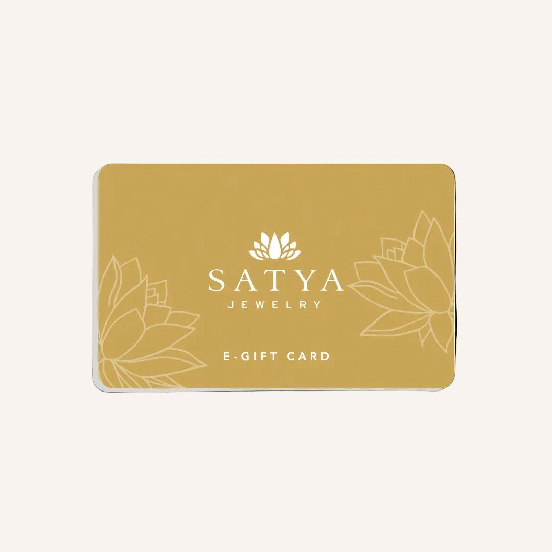 Elegant eGift Card design for SATYA Jewelry featuring a serene gold background with lotus patterns. Ideal for sharing meaningful gifts that embody spiritual jewelry values such as meditation, talisman energy, zodiac connections, and protection symbolism. Perfect for those seeking to manifest positivity and charm in their lives, aligning with yoga and spiritual practices.