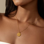 True Visionary White Topaz Evil Eye Coin Necklace showcased on a model, emphasizing its elegant design and spiritual significance. This stunning piece of spiritual jewelry acts as a talisman for protection and is perfect for those exploring the deeper meaning of zodiac energies in their lives.