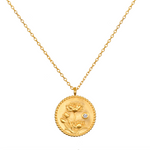 Joyful Beginnings Necklace features an intricate 18kt gold plated pendant adorned with lotus flowers and a white topaz stone, symbolizing new beginnings and individuality, perfect for spiritual jewelry, meditation, and meaningful charm.