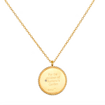 Joyful Beginnings Necklace featuring an 18kt gold plated pendant engraved with the words 'For the children of Ramana's Garden', symbolizing new beginnings and potential. This spiritual jewelry is perfect for meditation and serves as a meaningful talisman, ideal for yoga and manifestation practices. It embodies the essence of protection, charm, and the connection to the sun and moon symbolism.