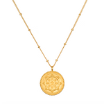 Pathway to Love Necklace in gold featuring a delicate lotus flower and Tibetan Wheel of Life pendant. This spiritual jewelry promotes meditation, embodying a talisman for zodiac signs and enhancing spiritual practices like yoga, offering protection and manifestation purpose.