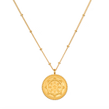 Pathway to Love Necklace in gold featuring a delicate lotus flower and Tibetan Wheel of Life pendant. This spiritual jewelry promotes meditation, embodying a talisman for zodiac signs and enhancing spiritual practices like yoga, offering protection and manifestation purpose.
